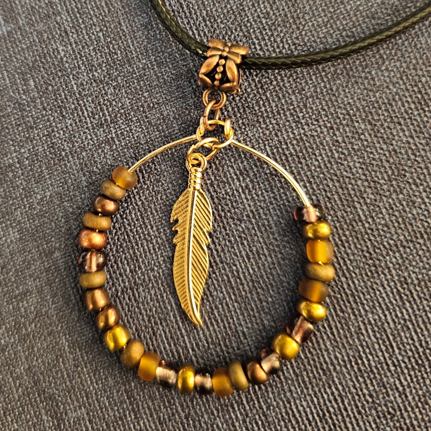 Hand-Shaped Beaded Hoop Necklace With Brown Feather