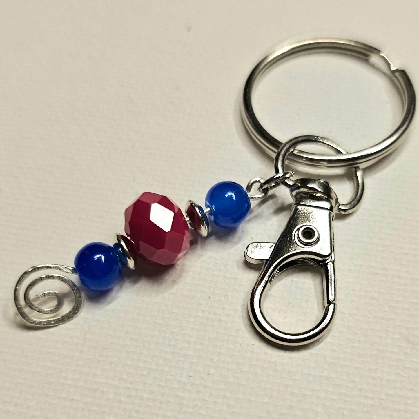 Blue and Red Keychain with a Silver Swirl