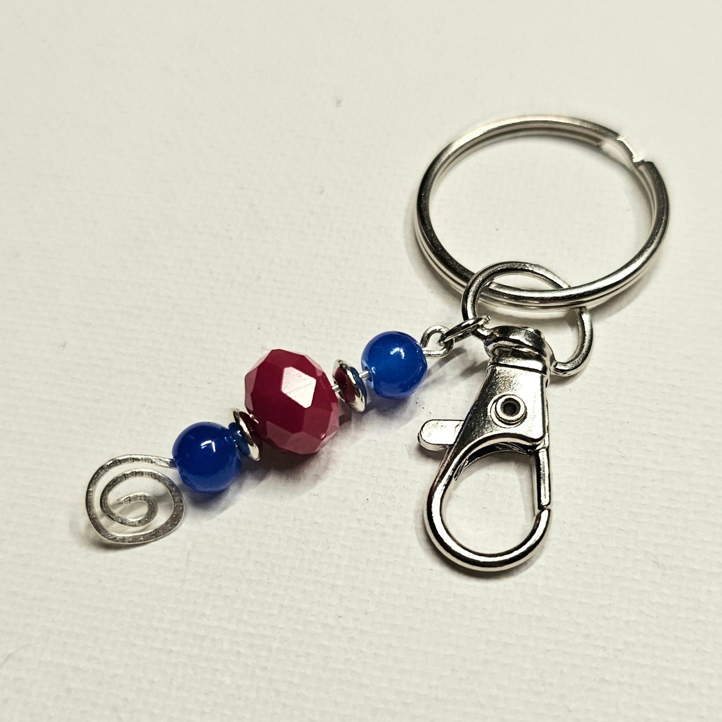 Blue and Red Keychain with a Silver Swirl